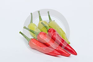 Close up green and red chili pepper on white background