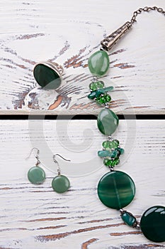 Close up green ring, earrings and jewellery.