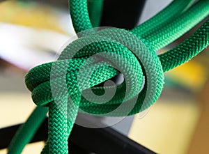 Close up green rope with knot on selective focus background
