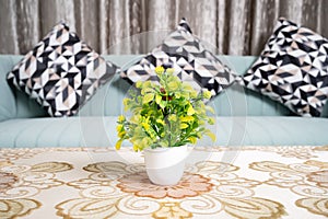 Modern living room and close up of green sofa with linen cushions