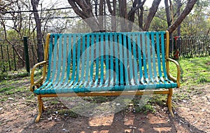 close up of green wooden bench in urban park during sunset time-wooden park bench at a park-Public park in summer