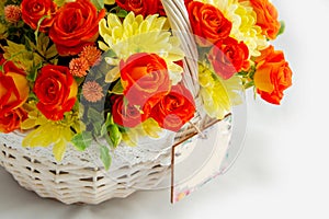 close-up greeting card on a white basket with scarlet roses and yellow chrysanthemums. white background for cutting