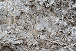 Close up grey lava rock face background texture