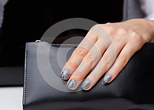 Close-up of grey nails with lace motives