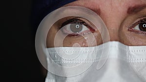 Close-up of Grief Stricken Tearful Doctor or Nurse Wearing Medical Face Mask