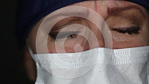 Close-up of Grief Stricken Tearful Doctor or Nurse Wearing Medical Face Mask