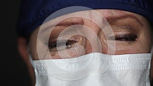 Close-up of Grief Stricken Tearful Doctor or Nurse Wearing Medical Face Mask