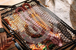 Close up grill with meat and sausage ready for cooking