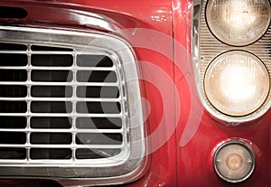 Close Up of Grille and Headlights of Red Vehicle
