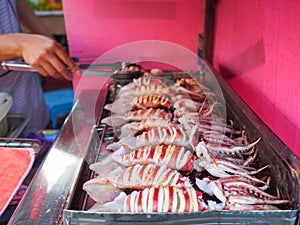 Close-up of grilling squids for sale in the market