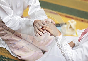 Close up Groom Put the Wedding Ring on bride. seletive focu. shallow dof.