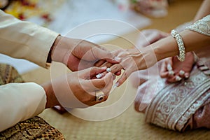 Close up Groom Put the Wedding Ring on bride in Thailand.