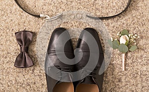 Close up of groom shoes and wedding accessories for him