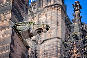 Close up of a grotesque gargoyle on the outside of Chester Cathedral, Chester, Cheshire, UK