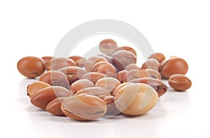 Close up of group of argan nuts on a white background.