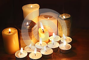 Group of burning candles in the dark