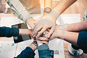 Close up of group of business people joining their hands togeth