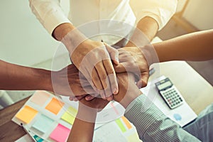 Close up of group of business people joining their hands together in unity