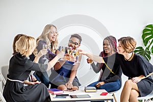 Close-up of group of businesspeople toasting glasses of champagne in the office