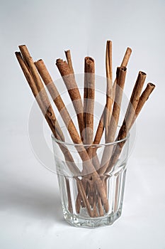 Close up of group cinnamon stick (Cinnamomum verum) in a glass on white background