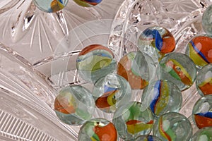 Close-up of a group of colorful glass marbles with natural shadows