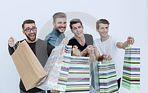 Close up.a group of friends with shopping bags pointing at you
