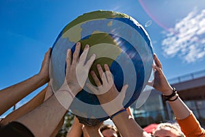 Close up of hands holding terrestrial globe photo