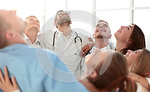 Close up. group of happy doctors standing in a circle