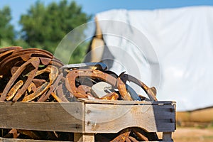 Close Up of a Group of Horsehoes in a Stable on Blur Background