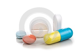 Close-up on group of medicine in capsule, caplet, tablet format on white background