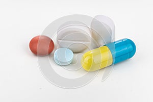 Close-up on group of medicine in capsule, caplet, tablet format on white background photo