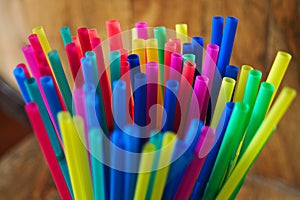Close up of a group of new colored plastic straws.