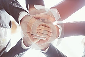 Close up of Group people of businessmen joining putting their hands together with stack of hands showing unity and teamwork. conce