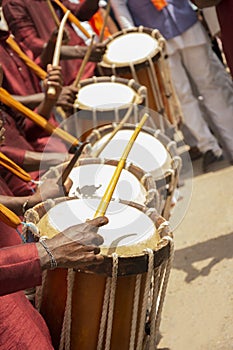 Close up of Group of People hands performing Indian art form Chenda or chande a cylindrical percussion playing during