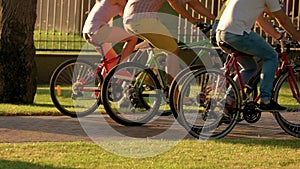 Close up group of people riding bicycles.