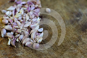 Close up group of small garlics on wooden texture board background