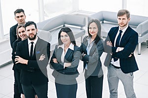 Close up.a group of successful business people standing in the office hall