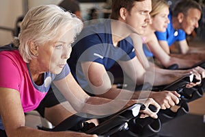 Close Up Of Group Taking Spin Class In Gym