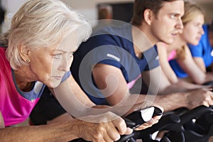 Close Up Of Group Taking Spin Class In Gym