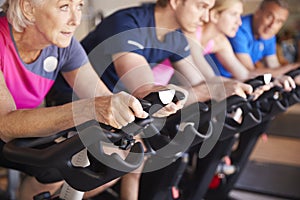 Close Up Of Group Taking Spin Class In Gym