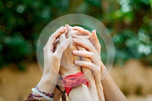 Close up of group of women hands up in the air hands holding tight each other as a symbol of feminism and feminine connection with