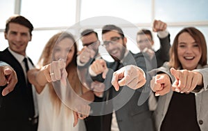 Close up.a group of young business people pointing at you