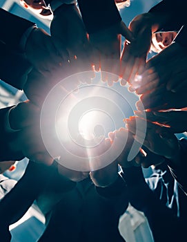 Close up. group of young business people standing in a circle.