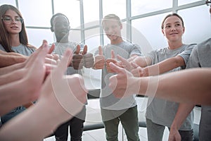 Close up. group of young people showing thumbs up.