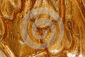 Close up of grunge golden potal texture. Foil on architectural detail. Cracelures and bitumen varnish. Selective macro focus photo