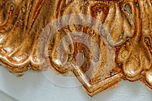 Close up of grunge golden potal texture. Foil on architectural detail. photo