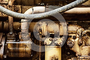 Close up of grungy old combustion engine from vintage tractor