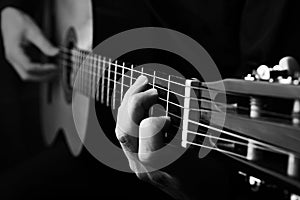 Close up of an guitar being played. Black and white photo