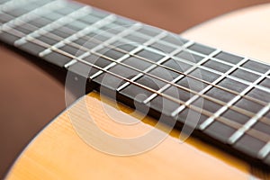 Close-up guitar body and neck, fretboard and deck and strings