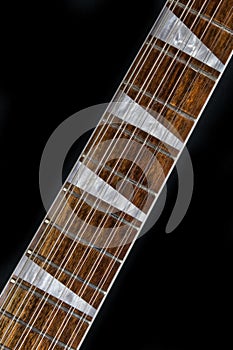 Close up of guitar with Chechen wood fretboard and unique triangular pearl inlays